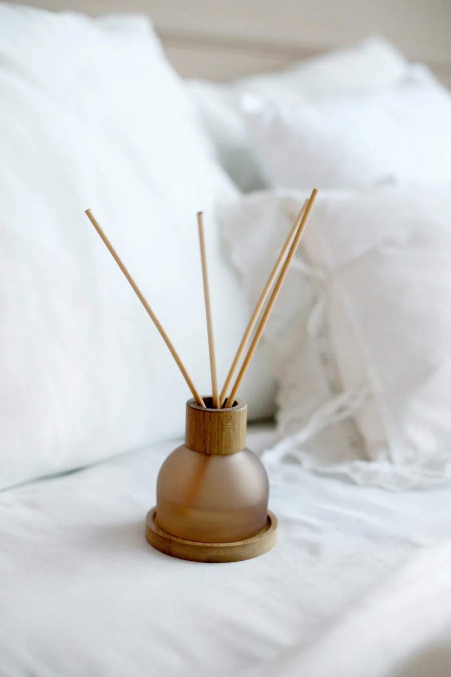 Reed diffuser on white linen
