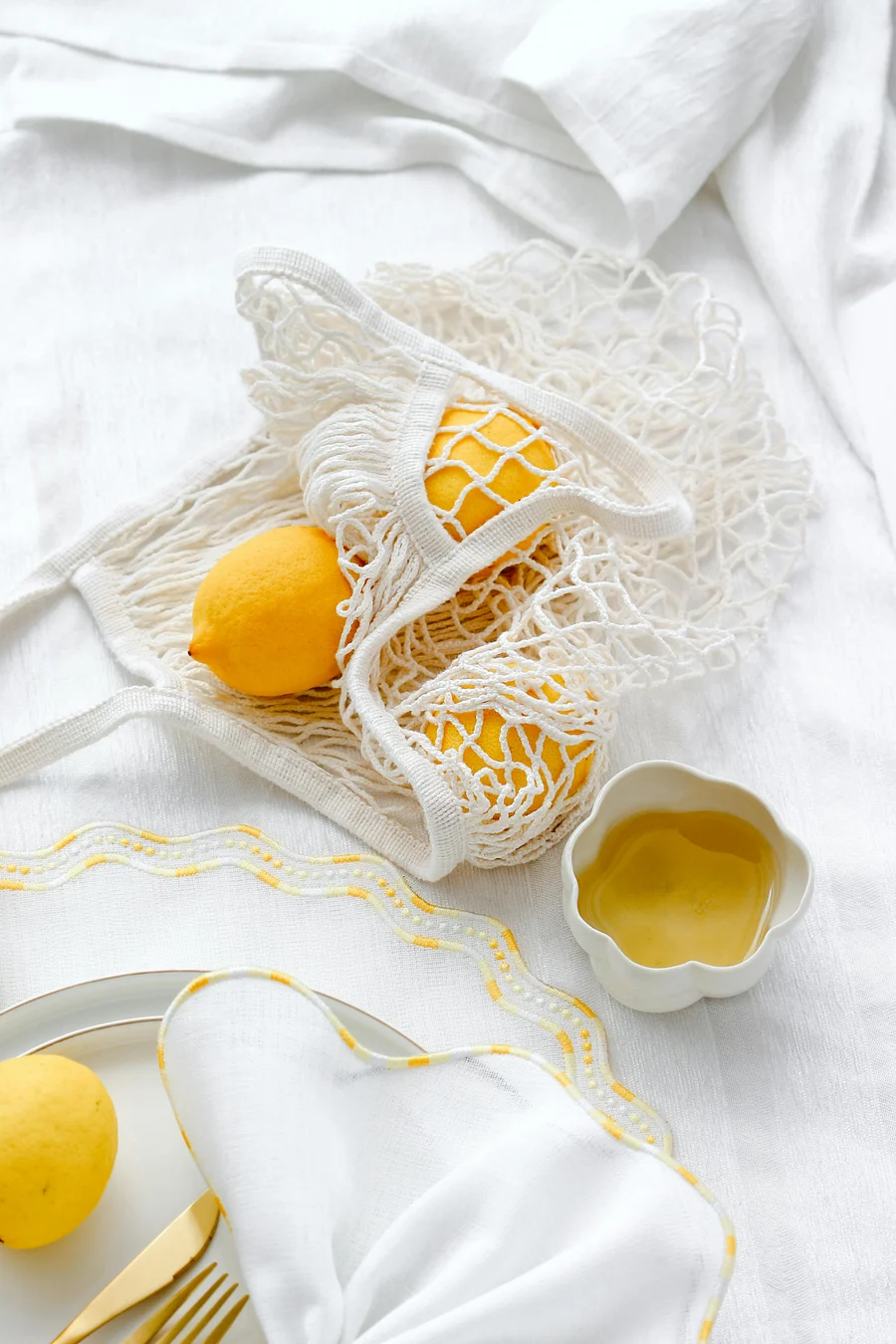 Lemons in a cotton mesh produce bag, zero-waste styling